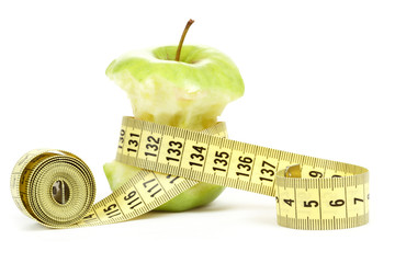 Green bitten apple isolated on white with measuring tape