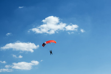 unidentified skydiver on blue sky