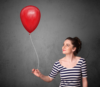Woman holding a red balloon