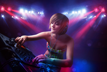 Plakat Teenager Dj mixing records in front of a crowd on stage