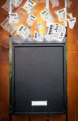 Post box with daily newspapers flying