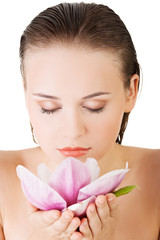 Woman with healthy clean skin and pink flowers