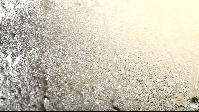 Close up of water dripping on glass