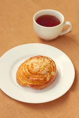 bun and cup of tea on tray