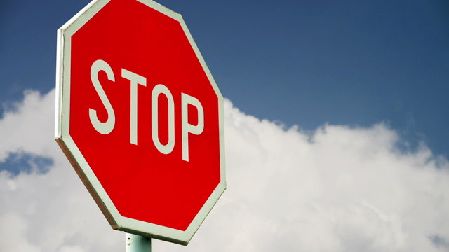Red stop sign on the street. Roadside traffic sign for stopping 