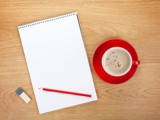 Blank notepad with office supplies and red coffee cup