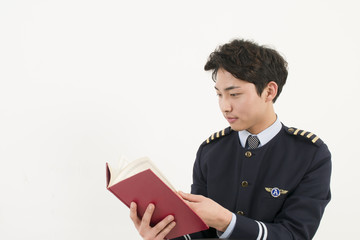 Airline pilot reading a book © blueperfume