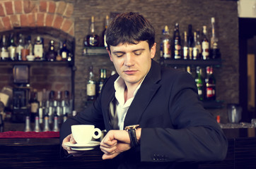 man drinking coffee in a restaurant