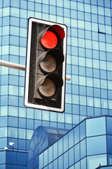 Traffic lights over modern business architecture