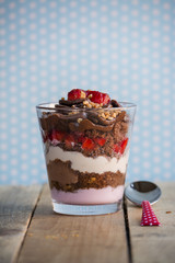 Chocolate cake dessert, yogurt and strawberries, polka dot backg
