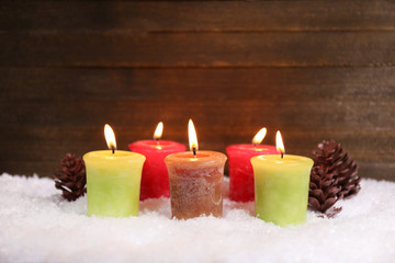Burning candles on wooden background