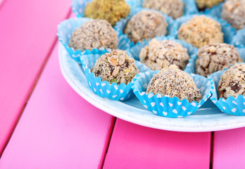 Set of chocolate candies, on wooden background