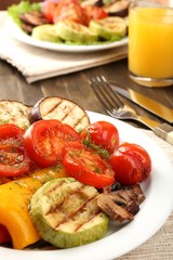 Delicious grilled vegetables on plate on table close-up