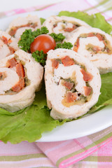 Delicious chicken roll on plate on table close-up