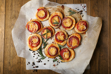 Small pizzas on baking paper close up