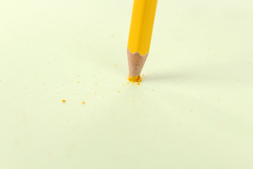 Breaking pencil on paper, close up