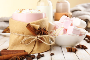Mug of hot drink decorated in felt on wooden table
