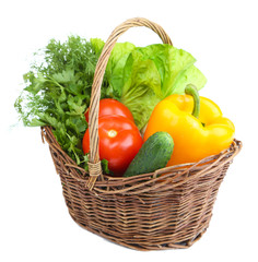 Composition with raw vegetables in wicker basket isolated