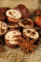 Tasty chocolate candies with coffee beans and nuts, close up