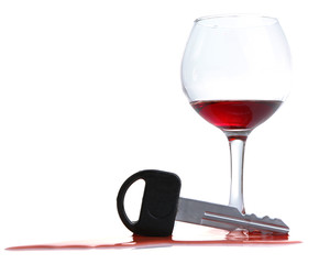 Composition with car key and glass of wine, isolated on white