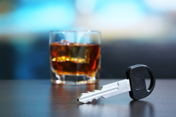 Composition with car key and glass of whiskey,