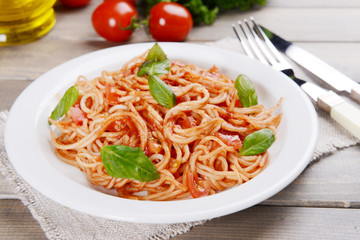 Pasta with tomato sauce on plate on table close-up