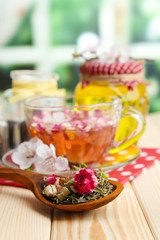 Assortment of herbs, honey and tea in glass jars