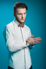 Stylish businessman on blue background