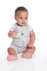 Portrait of a Baby Boy Wearing Overalls with Sailboat Decal