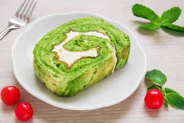Green tea roll cake on plate