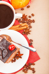 Cup of coffee with spices and chocolate cake with cherry
