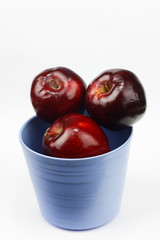 Red apples in blue container