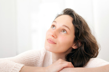 Portrait of an attractive thinking girl with curly hair