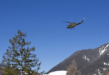 Fototapeta na wymiar Military helicopter over Alps.