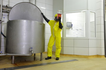 checking sample at large industrial tank in plant