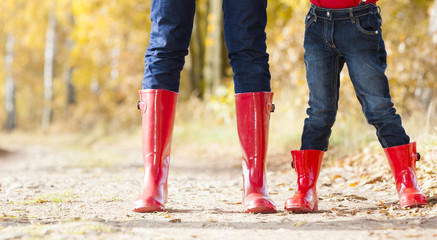 detail of mother and daughter wearing rubber boots