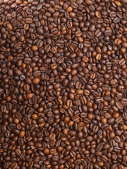 Numerous coffee beans which have been scattered all over the sur