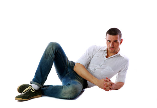Confident man laying on the floor over white background