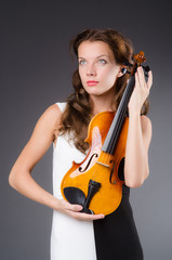Woman artist with violin in music concept