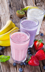 Fresh fruits milk shake on wood