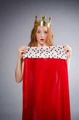 Queen in red dress in studio