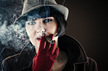 beautiful glamorous woman in retro style with cigar