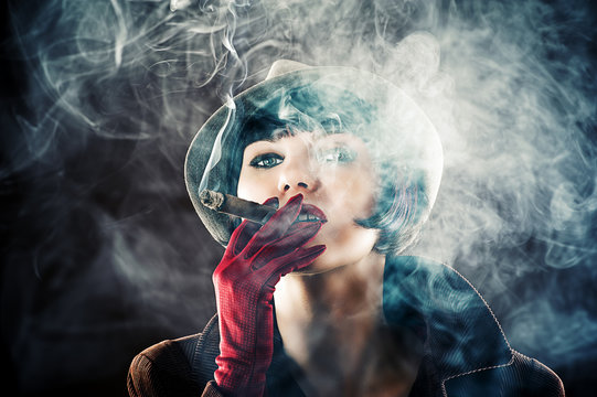 beautiful glamorous woman in retro style with cigar