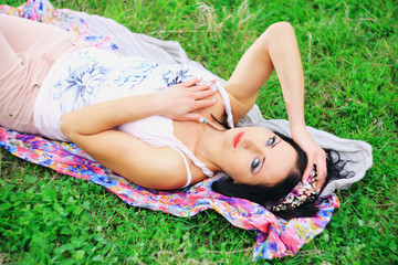 Obraz na płótnie Canvas young girl lay on the grass