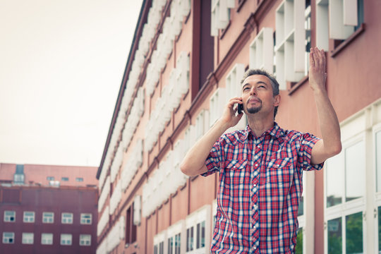 Man in short sleeve shirt talking on phone