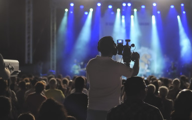 Fototapeta na wymiar Cameraman silhouette on a concert stage