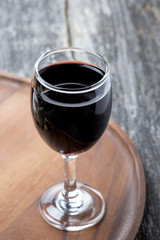 glass of red wine on a wooden board