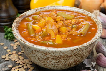 Spicy tomato soup with lentils and vegetables in a bowl