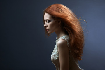 beautiful red-haired girl in the dark