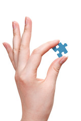 female arm holding puzzle piece